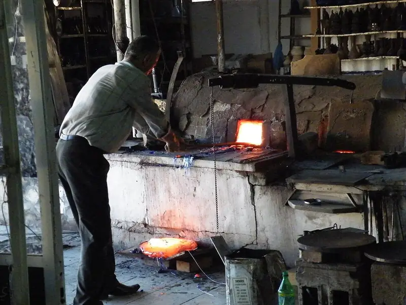 A glassblower at work in a Hebron glass factory.