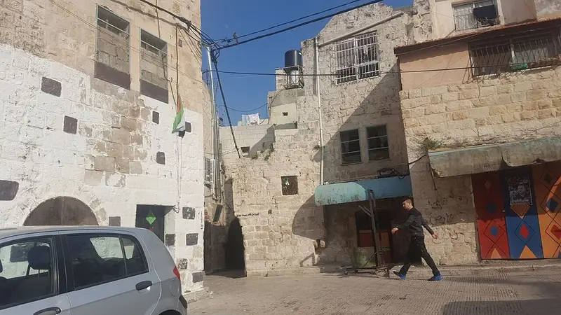 A narrow street of stone houses in the old city of Nablus.