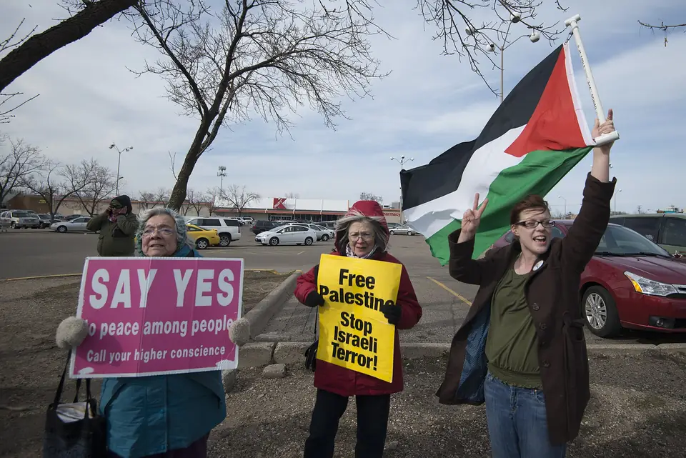 Demonstrators with a Palestinian flag and placards on Lake Street, Minneapolis, April 2016.